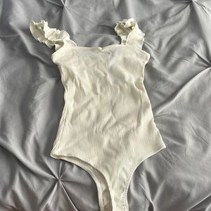white bodysuit with ruffled straps